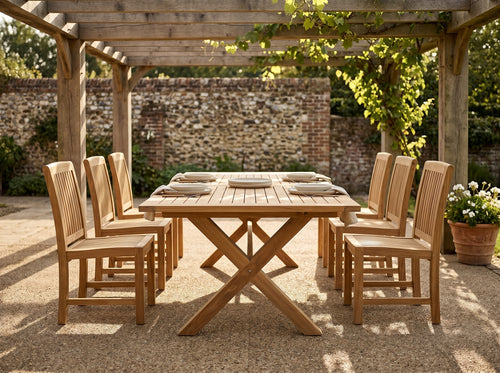 teak cross leg rectangular outdoor dining table in outdoor setting