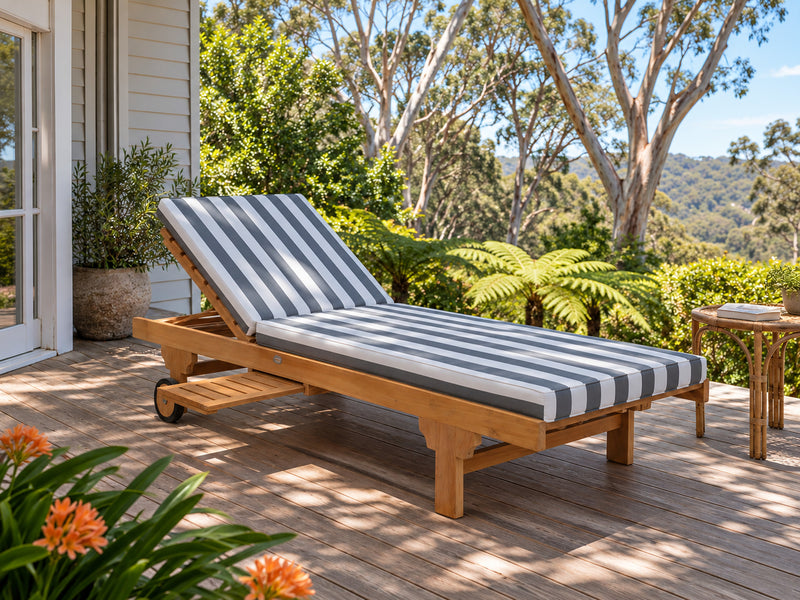 Extra Wide teak pool lounge with a denim stripe cushion on a timber verandah, with tree ferns beyond