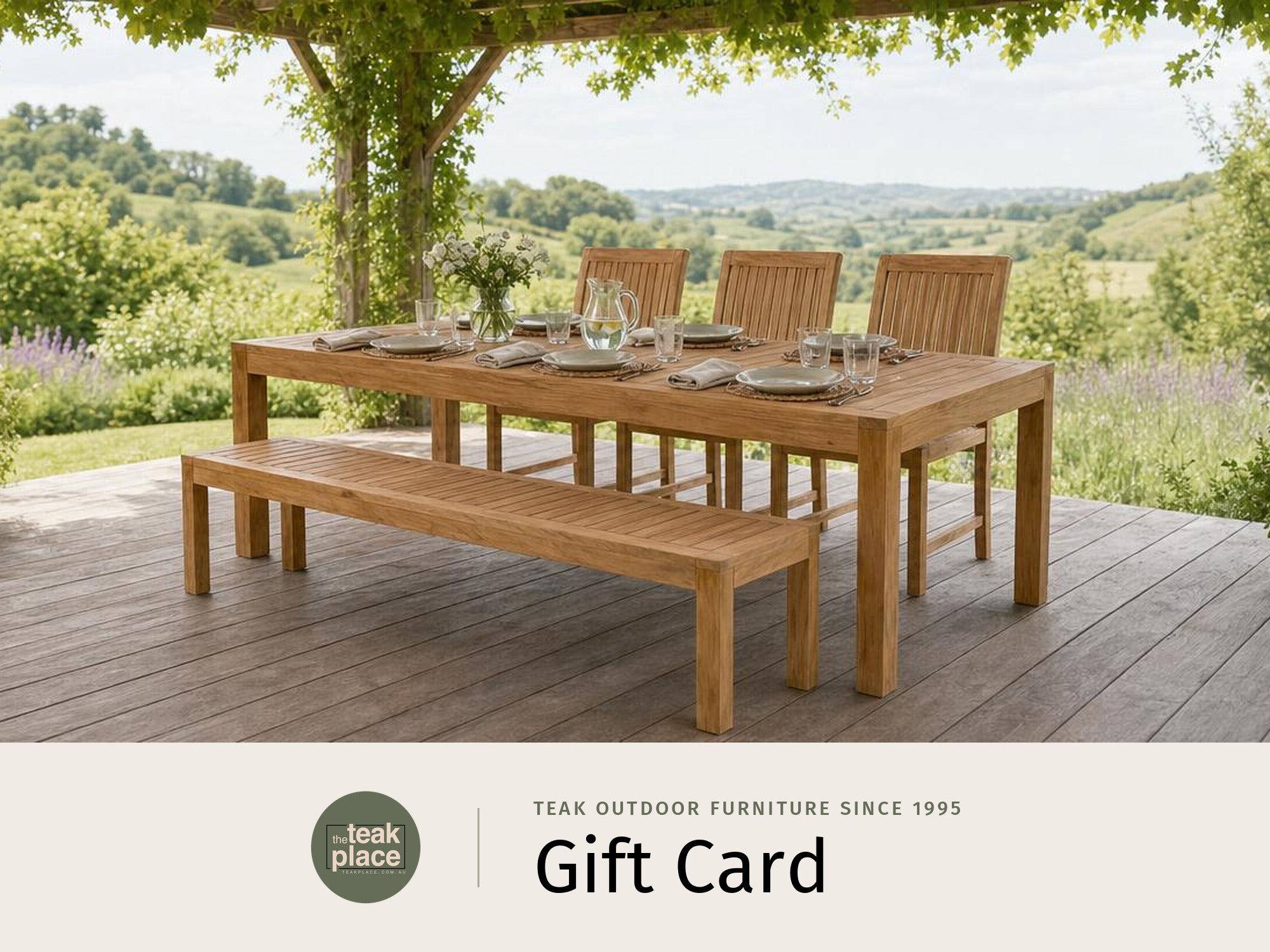 The Teak Place gift card, showing a teak outdoor dining table with a bench and chairs on a timber deck